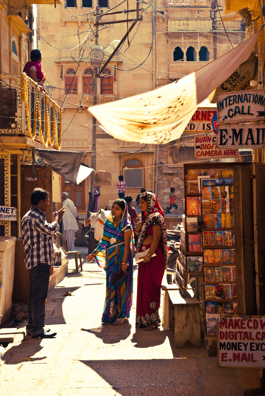 A sunlit street with people and shops