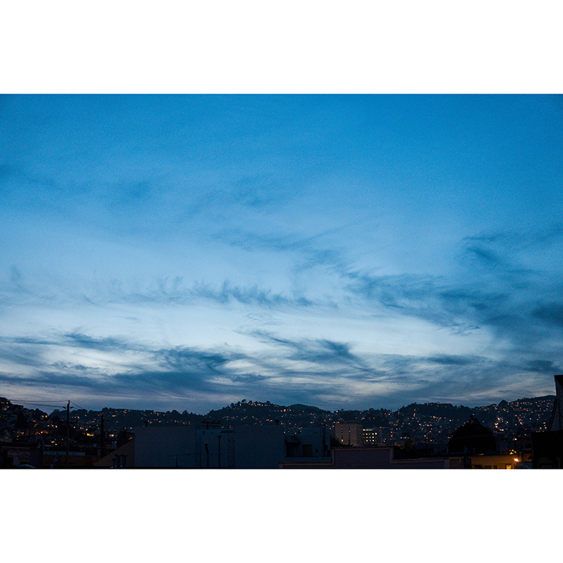 A city below a wide blue sky