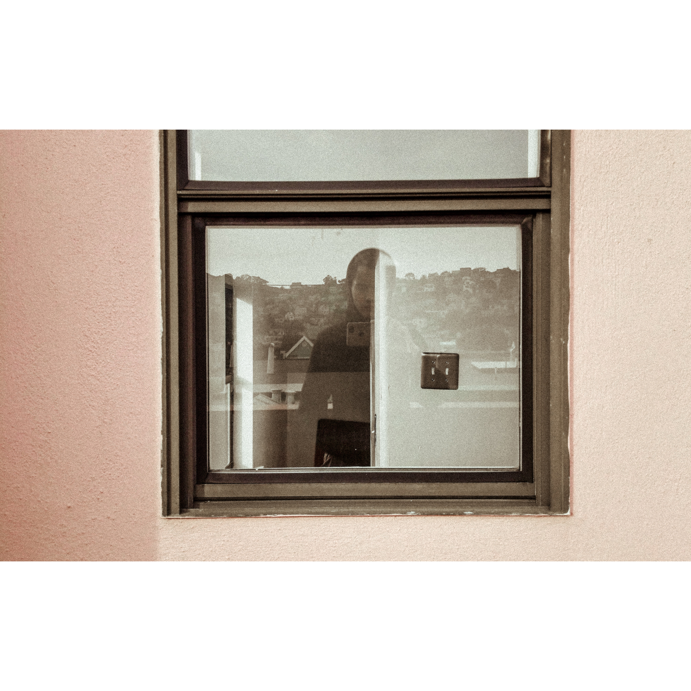 A figure and buildings overlapping in a window